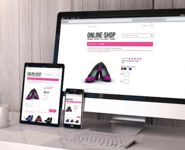Digital generated devices on desktop, responsive mock-up with online shop website on screen. All screen graphics are made up.